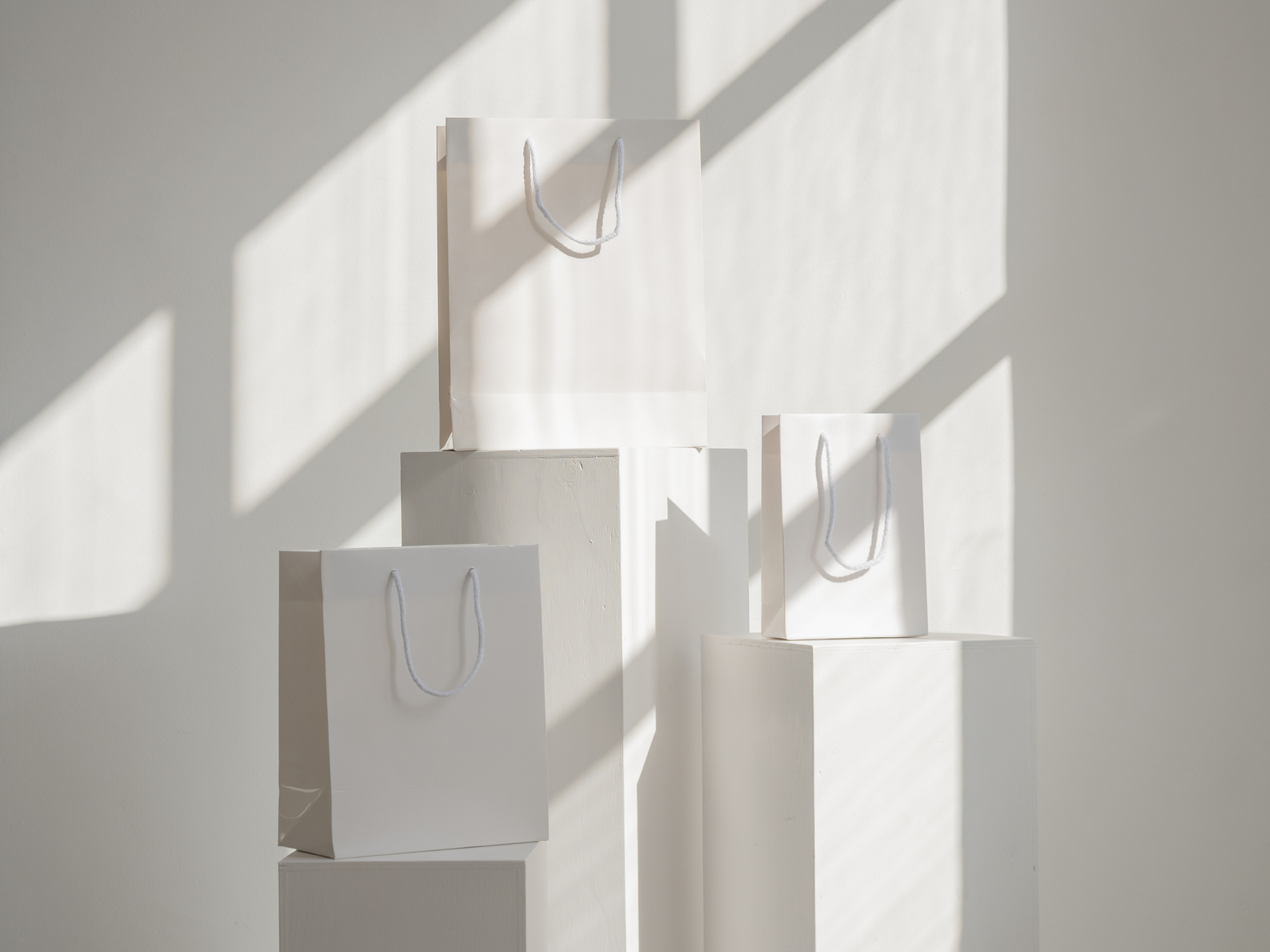 Display of aesthetic white and neutral-toned branding materials, representing calm, creative inspiration for women entrepreneurs and stay-at-home moms building their dream brands from home.